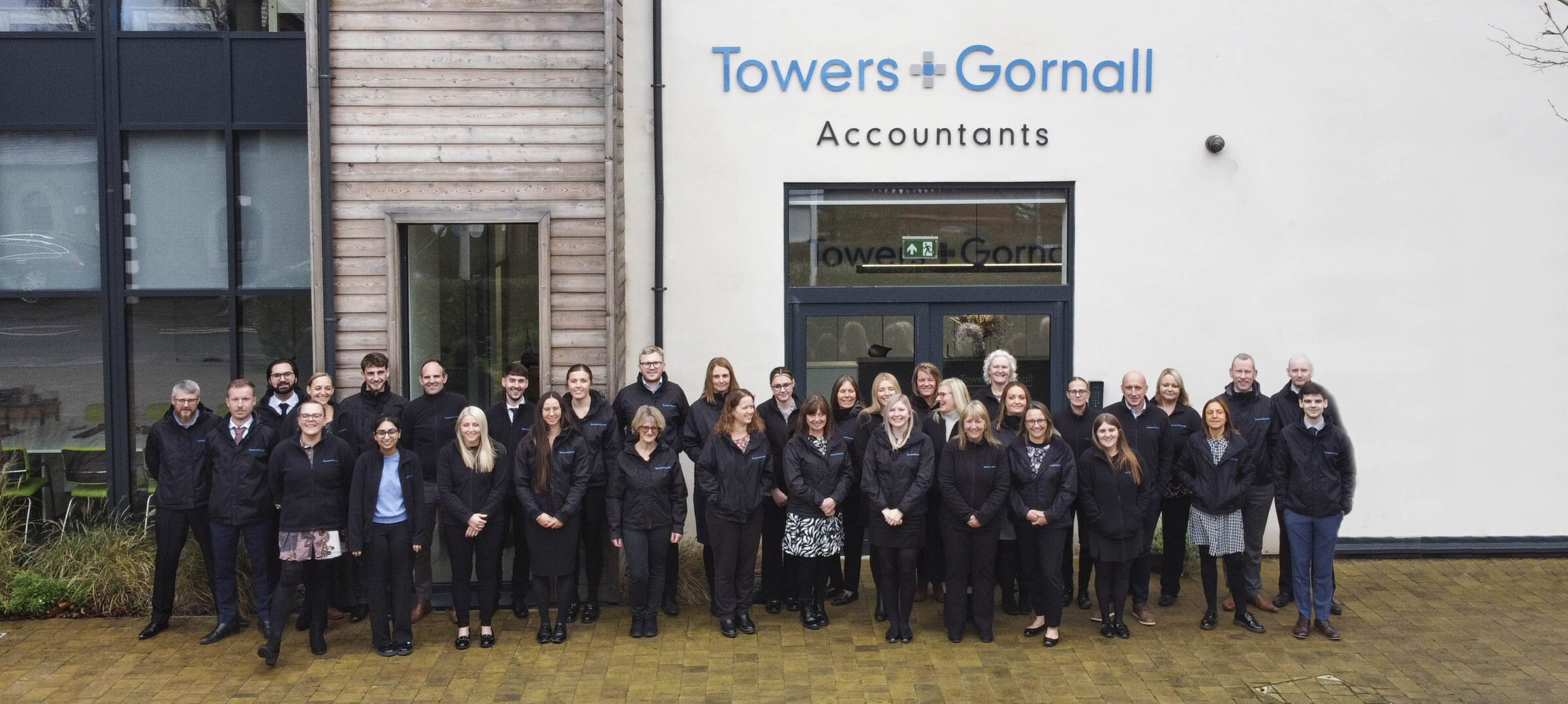 TOWERS AND GORNALL STAFF STOOD OUTSIDE OFFICE