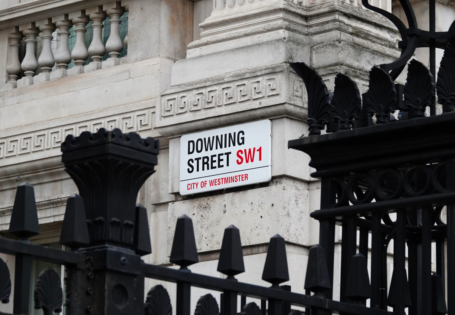 Downing Street sign on the wall of government building in Westminster, London, UK.