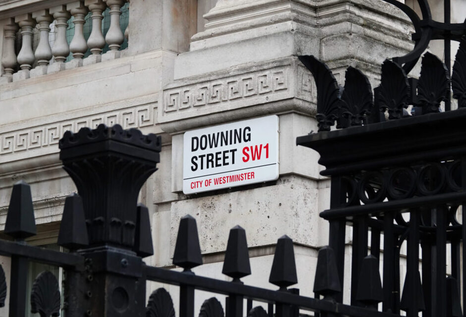 Downing Street sign on the wall of government building in Westminster, London, UK.