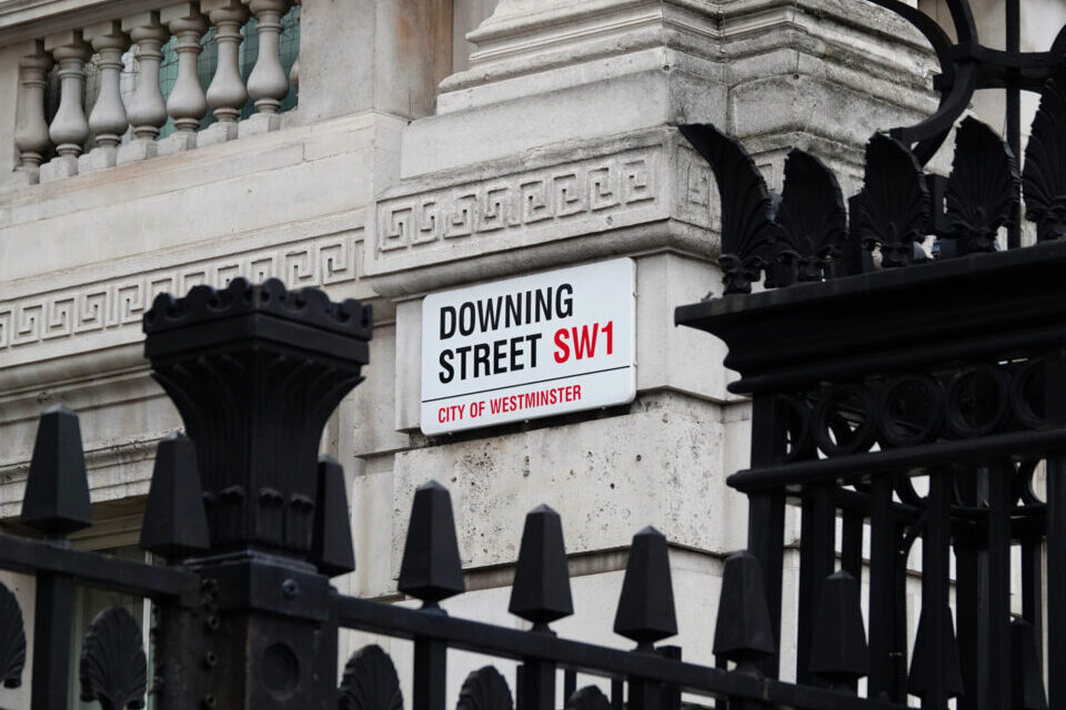 Downing Street sign on the wall of government building in Westminster, London, UK.